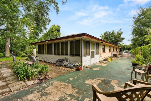 5268 Pinto Way, Orlando, FL 32810 - view of property exterior with a sunroom