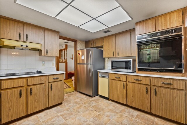 5268 Pinto Way, Orlando, FL 32810 - kitchen with black appliances, under cabinet range hood, light countertops, and tasteful backsplash