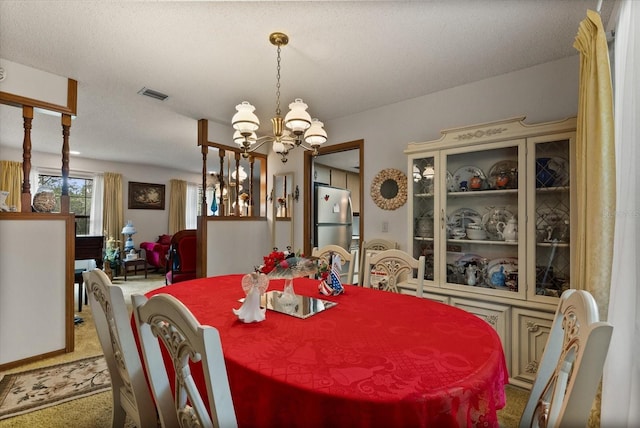 5268 Pinto Way, Orlando, FL 32810 - dining room featuring a chandelier and light carpet