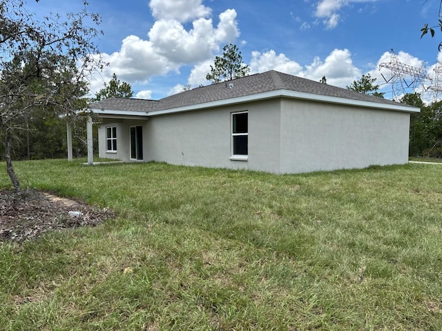 6805 N Sandborn Loop, Citrus Springs, FL 34433 - back of house featuring stucco siding and a lawn