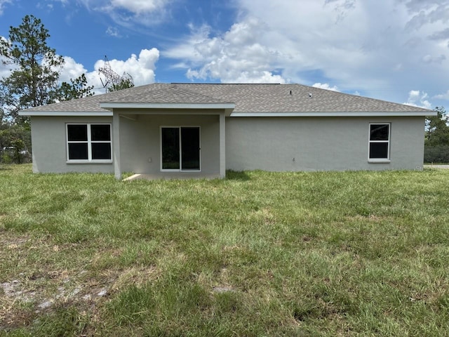 6805 N Sandborn Loop, Citrus Springs, FL 34433 - back of house with stucco siding, a lawn, and roof with shingles