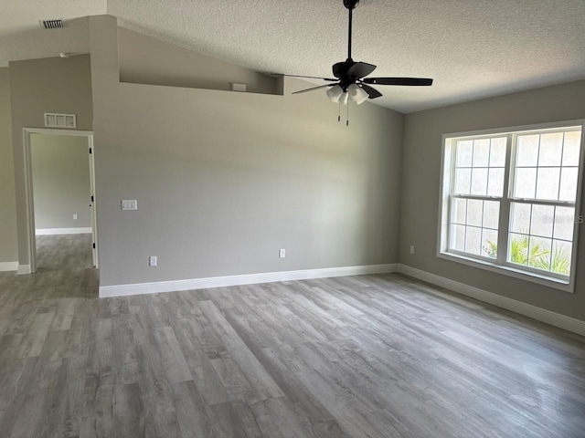 6805 N Sandborn Loop, Citrus Springs, FL 34433 - unfurnished room with ceiling fan, wood finished floors, a textured ceiling, and vaulted ceiling
