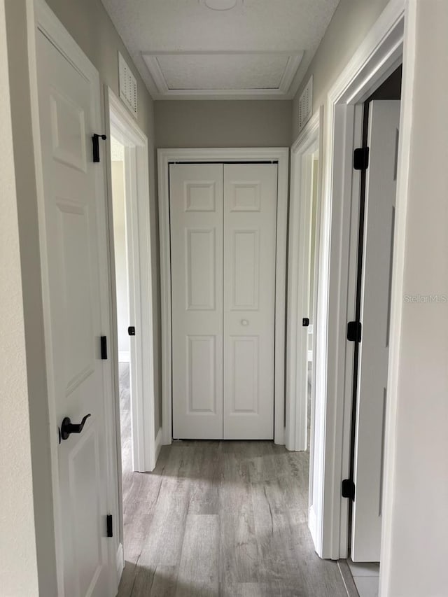 6805 N Sandborn Loop, Citrus Springs, FL 34433 - corridor featuring wood finished floors and attic access