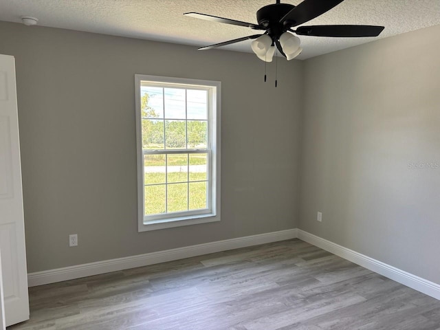 6805 N Sandborn Loop, Citrus Springs, FL 34433 - empty room with a smoke detector, ceiling fan, wood finished floors, and a textured ceiling