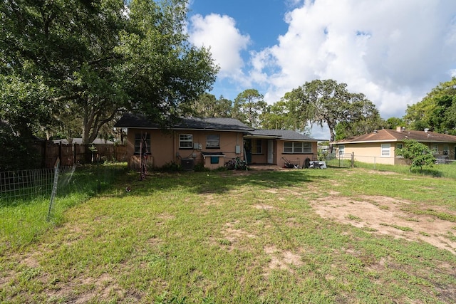 303 W Dicie Ave, Eustis, FL 32726 - rear view of house featuring a fenced backyard and stucco siding