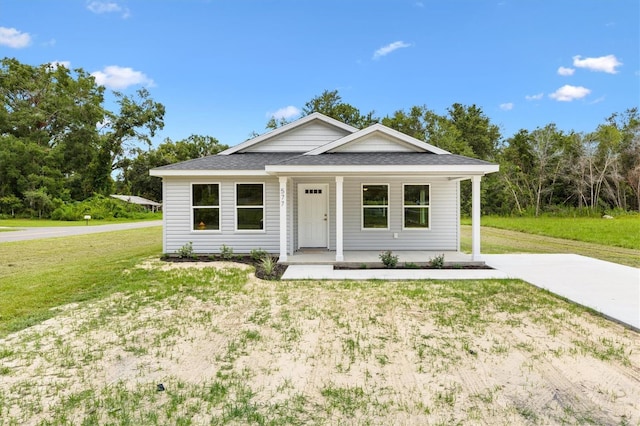 577 E Anderson Ave, Bushnell, FL 33513 - view of front of property with a porch, a front yard, and roof with shingles