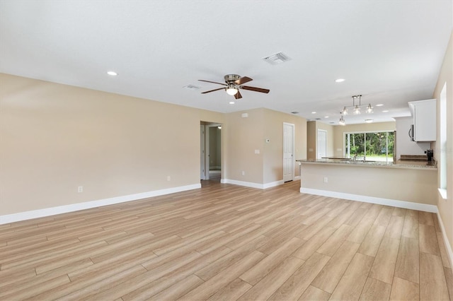 577 E Anderson Ave, Bushnell, FL 33513 - unfurnished living room with light wood-style floors, a ceiling fan, and recessed lighting