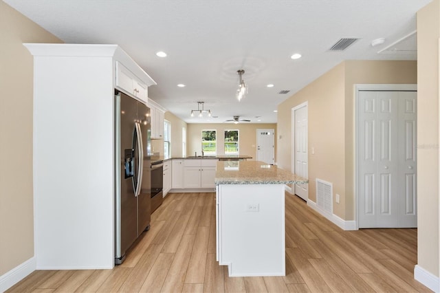 577 E Anderson Ave, Bushnell, FL 33513 - kitchen featuring stainless steel fridge with ice dispenser, light wood-style flooring, a peninsula, white cabinetry, and recessed lighting