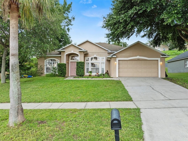 1532 Nightfall Dr, Clermont, FL 34711 - ranch-style home featuring driveway, a front yard, stucco siding, and a garage