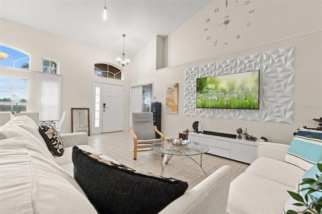 1532 Nightfall Dr, Clermont, FL 34711 - living room featuring a chandelier, light tile patterned floors, and high vaulted ceiling