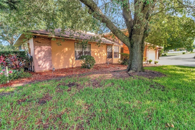 9835 Lakeshore Dr, Clermont, FL 34711 - view of front facade featuring brick siding, concrete driveway, and a garage
