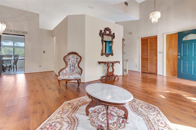 9835 Lakeshore Dr, Clermont, FL 34711 - foyer featuring a chandelier, a towering ceiling, and wood finished floors