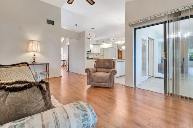 9835 Lakeshore Dr, Clermont, FL 34711 - living room featuring a chandelier, light wood-type flooring, and a ceiling fan