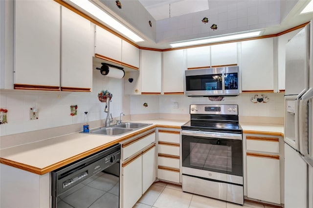 9835 Lakeshore Dr, Clermont, FL 34711 - kitchen with stainless steel appliances, decorative backsplash, light countertops, and white cabinetry
