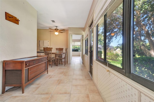 9835 Lakeshore Dr, Clermont, FL 34711 - hallway featuring light tile patterned flooring and wallpapered walls