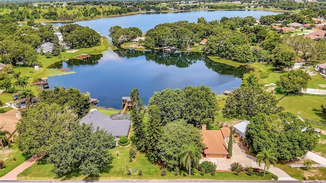 9835 Lakeshore Dr, Clermont, FL 34711 - aerial perspective of suburban area with a nearby body of water and a tree filled landscape