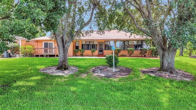 9835 Lakeshore Dr, Clermont, FL 34711 - back of house with a lawn, a wooden deck, and roof with shingles