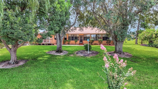 9835 Lakeshore Dr, Clermont, FL 34711 - view of grassy yard featuring a deck and a sunroom
