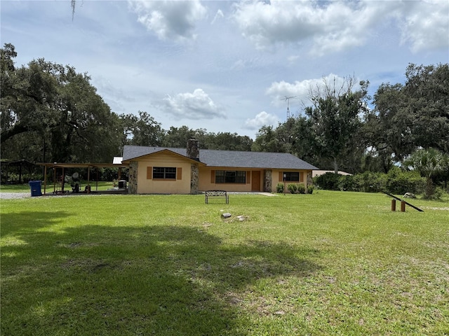 2747 County Road 615, Bushnell, FL 33513 - view of front facade featuring a front lawn, a chimney, and stucco siding