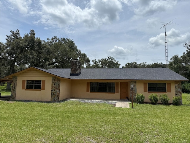 2747 County Road 615, Bushnell, FL 33513 - ranch-style home with a front lawn, a chimney, stucco siding, and roof with shingles