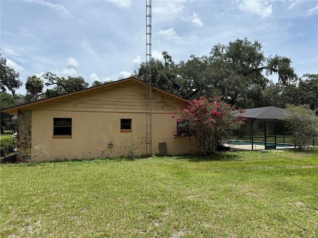 2747 County Road 615, Bushnell, FL 33513 - view of property exterior with a yard, stucco siding, and an outdoor pool