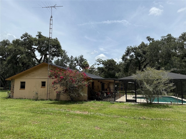 2747 County Road 615, Bushnell, FL 33513 - back of property featuring a yard, an outdoor pool, a patio area, and stucco siding