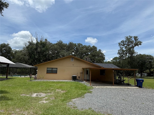 2747 County Road 615, Bushnell, FL 33513 - back of property featuring a lawn and an attached carport