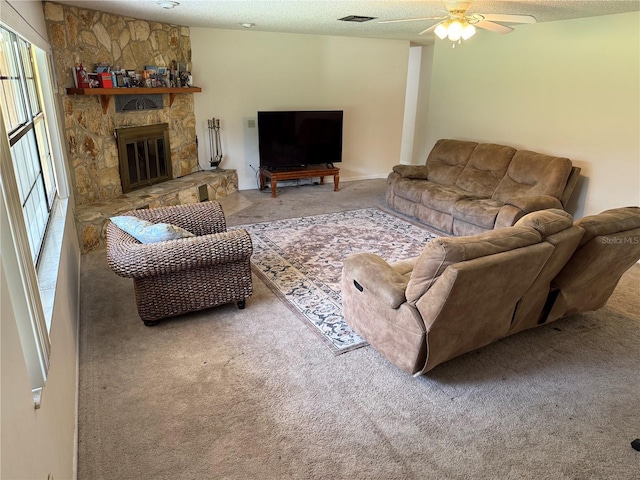 2747 County Road 615, Bushnell, FL 33513 - living room featuring carpet, ceiling fan, a fireplace, and a textured ceiling