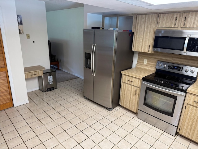 2747 County Road 615, Bushnell, FL 33513 - kitchen featuring appliances with stainless steel finishes, light countertops, light tile patterned floors, and light brown cabinetry