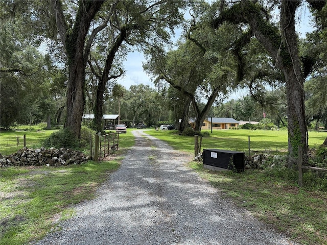 2747 County Road 615, Bushnell, FL 33513 - view of dirt / gravel driveway featuring a gated entry
