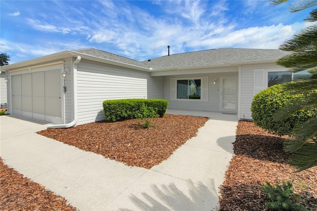 17707 SE 92nd Grantham Ter, The Villages, FL 32162 - view of front of property featuring a garage, concrete driveway, and a shingled roof
