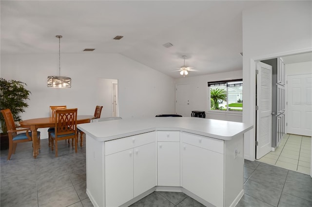 17707 SE 92nd Grantham Ter, The Villages, FL 32162 - kitchen featuring lofted ceiling, light countertops, hanging light fixtures, ceiling fan, and white cabinetry