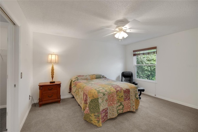 17707 SE 92nd Grantham Ter, The Villages, FL 32162 - bedroom with carpet, a textured ceiling, and a ceiling fan