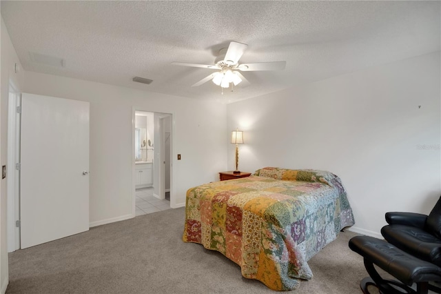 17707 SE 92nd Grantham Ter, The Villages, FL 32162 - bedroom featuring carpet floors, a textured ceiling, a ceiling fan, and connected bathroom