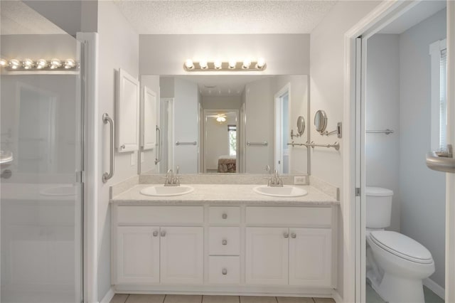 17707 SE 92nd Grantham Ter, The Villages, FL 32162 - full bathroom featuring double vanity, a textured ceiling, ceiling fan, a shower stall, and connected bathroom