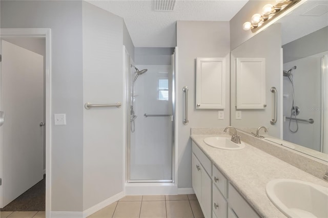 17707 SE 92nd Grantham Ter, The Villages, FL 32162 - bathroom with a stall shower, double vanity, tile patterned floors, and a textured ceiling