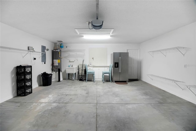 17707 SE 92nd Grantham Ter, The Villages, FL 32162 - garage featuring stainless steel fridge, electric panel, water heater, and a garage door opener