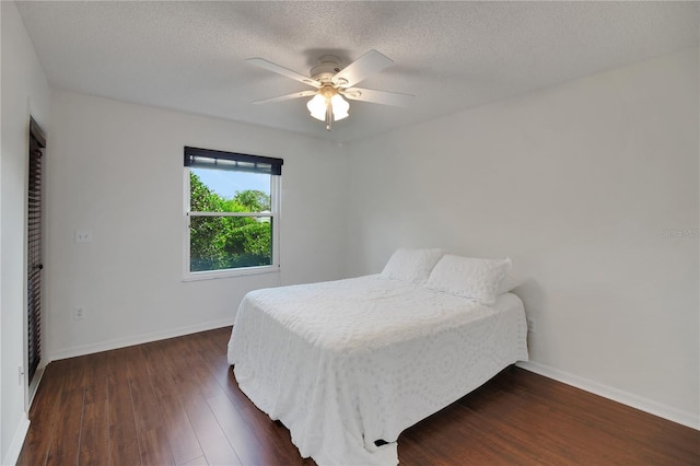 17707 SE 92nd Grantham Ter, The Villages, FL 32162 - bedroom with dark wood finished floors, a textured ceiling, and ceiling fan