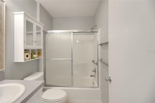 17707 SE 92nd Grantham Ter, The Villages, FL 32162 - bathroom featuring vanity, a textured ceiling, and bath / shower combo with glass door