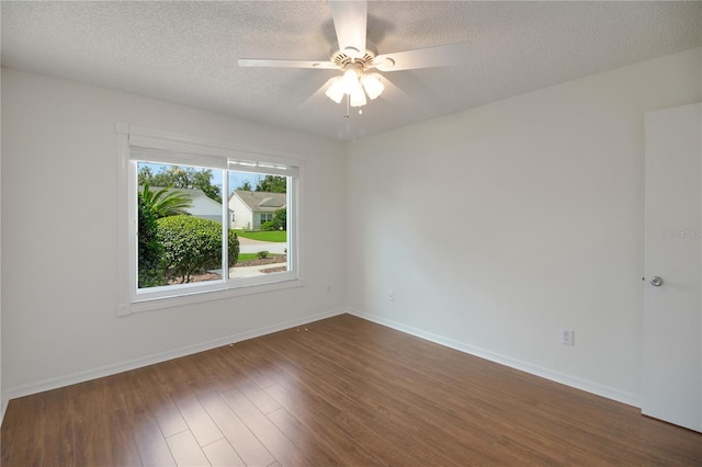 17707 SE 92nd Grantham Ter, The Villages, FL 32162 - empty room with dark wood finished floors, ceiling fan, and a textured ceiling