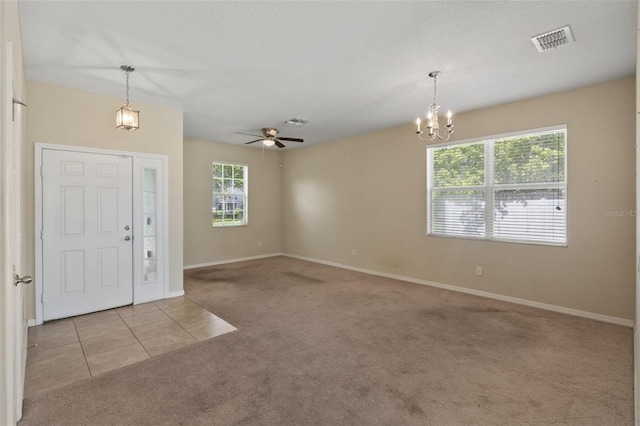 2215 Natoma Blvd, Mount Dora, FL 32757 - carpeted entryway featuring plenty of natural light, a chandelier, a ceiling fan, and tile patterned flooring