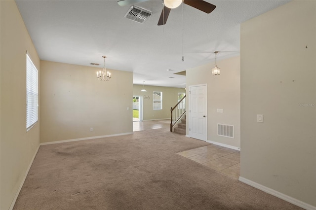 2215 Natoma Blvd, Mount Dora, FL 32757 - spare room featuring carpet, a chandelier, a ceiling fan, and stairway