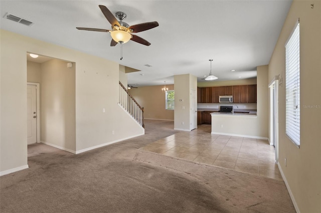 2215 Natoma Blvd, Mount Dora, FL 32757 - unfurnished living room featuring light colored carpet, stairs, light tile patterned flooring, ceiling fan, and recessed lighting