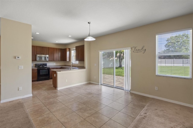 2215 Natoma Blvd, Mount Dora, FL 32757 - kitchen with black / electric stove, stainless steel microwave, light tile patterned flooring, light countertops, and a peninsula