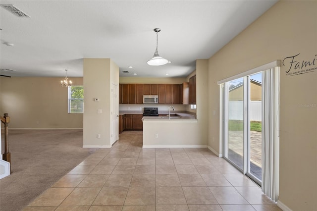 2215 Natoma Blvd, Mount Dora, FL 32757 - kitchen with open floor plan, stainless steel microwave, a chandelier, light countertops, and light tile patterned flooring