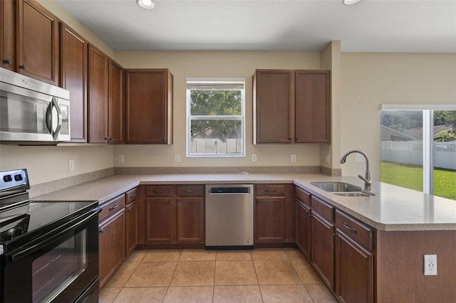 2215 Natoma Blvd, Mount Dora, FL 32757 - kitchen with stainless steel appliances, a peninsula, light tile patterned flooring, light countertops, and recessed lighting