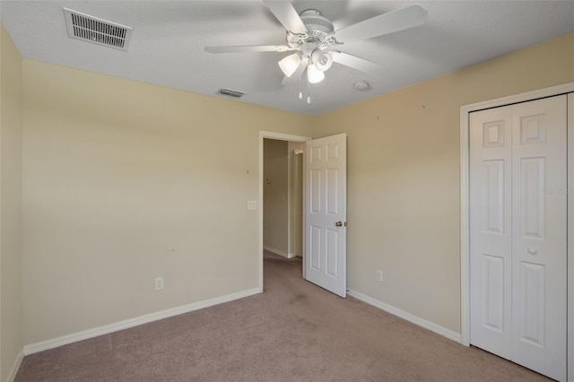 2215 Natoma Blvd, Mount Dora, FL 32757 - unfurnished bedroom with light carpet, a closet, and a ceiling fan