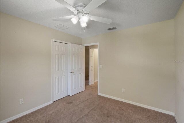 2215 Natoma Blvd, Mount Dora, FL 32757 - unfurnished bedroom featuring carpet floors, a closet, and a ceiling fan