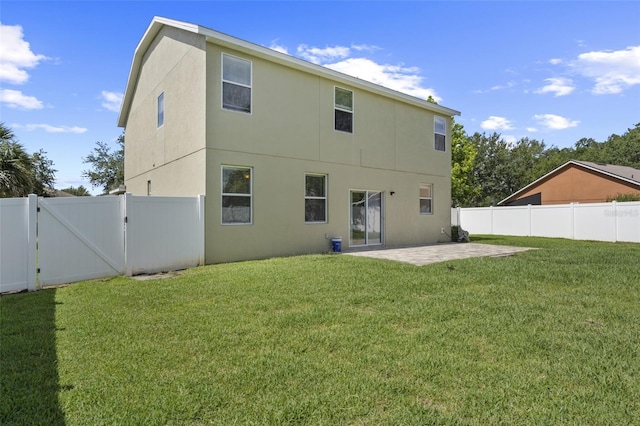 2215 Natoma Blvd, Mount Dora, FL 32757 - rear view of house featuring a gate, a patio area, a fenced backyard, and stucco siding