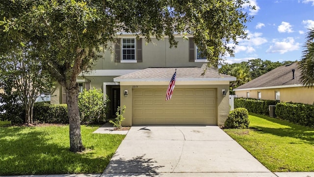 2215 Natoma Blvd, Mount Dora, FL 32757 - view of front of house featuring a front yard, stucco siding, concrete driveway, and roof with shingles